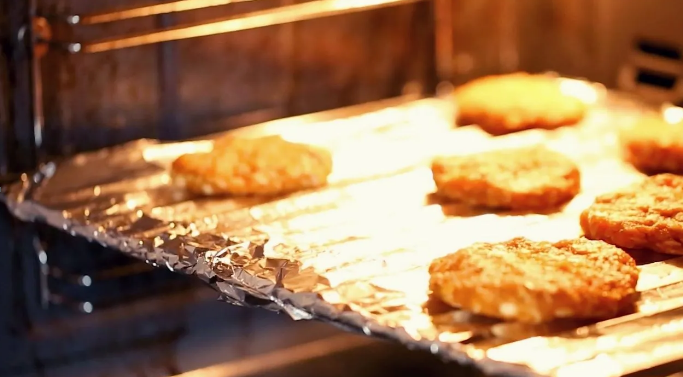 cookies placed on aluminum foil in the oven