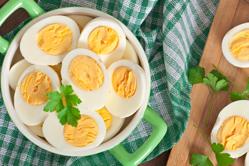 Boiled eggs in a bowl decorated with parsley leaves cut in halves