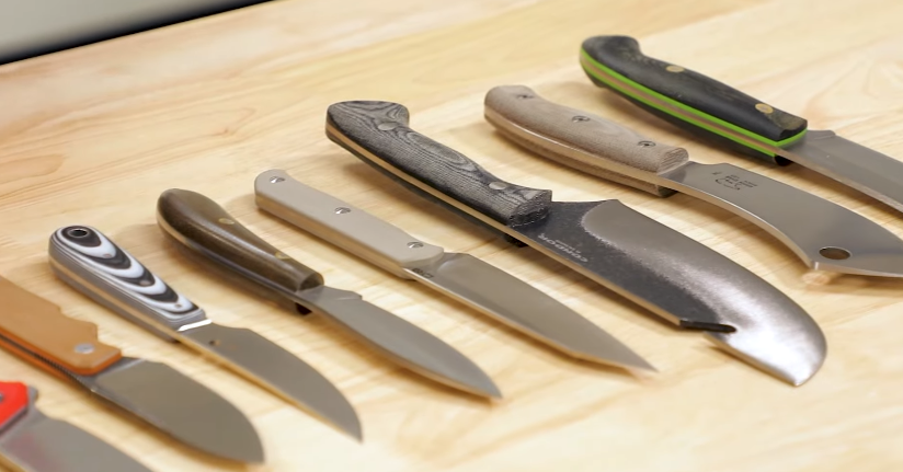 several knives of various blade types placed on the table