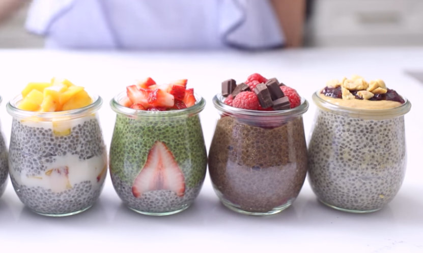 various chia puddings with fruits in glass cups
